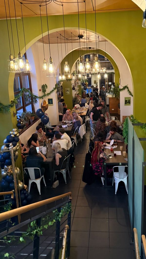 The arched dining room at The Bach, Dundee, busy with diners under hanging lights